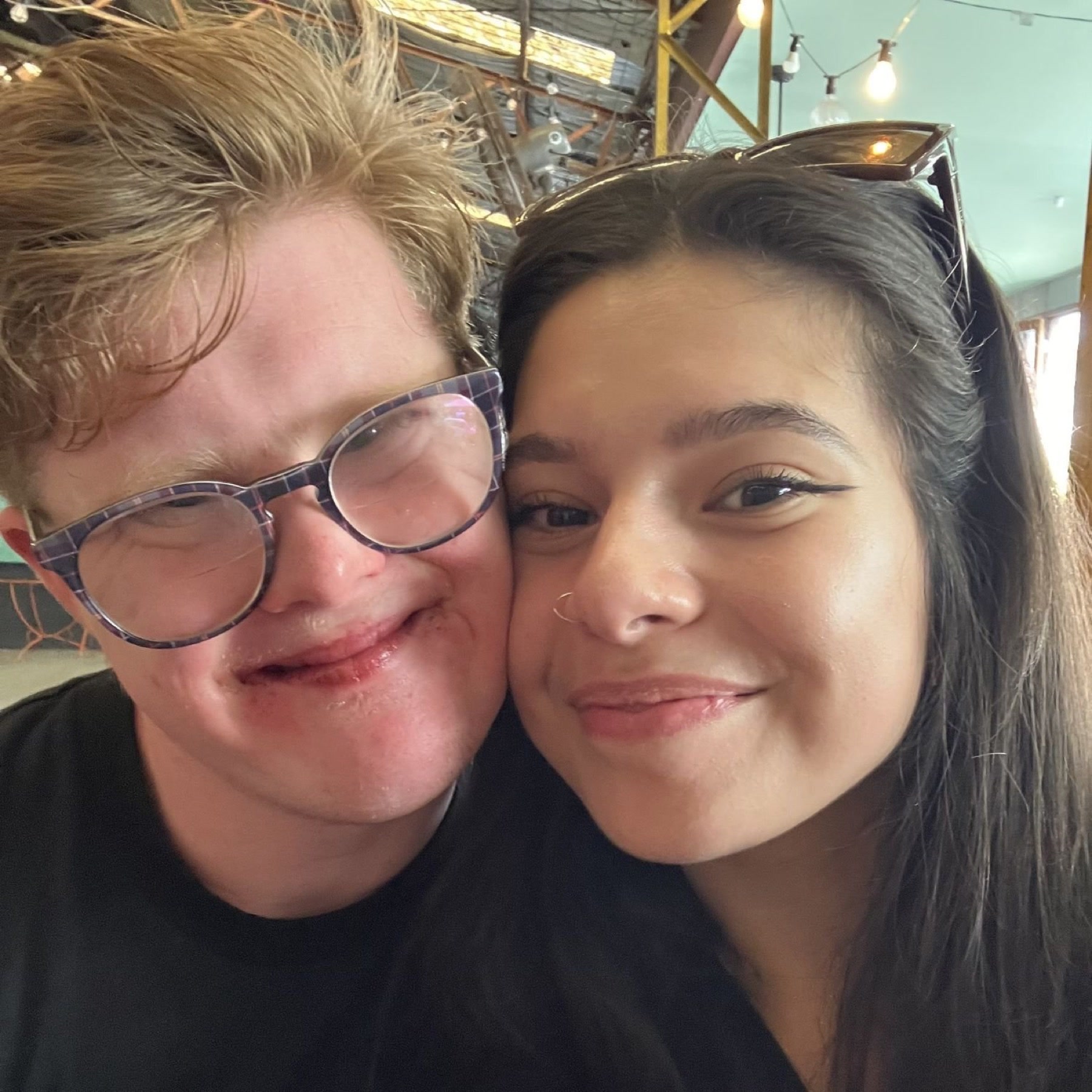 A participant and HORIZONS support worker smiling together during a community outing